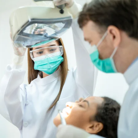 Dental providers conducting an exam on a patient under sedation